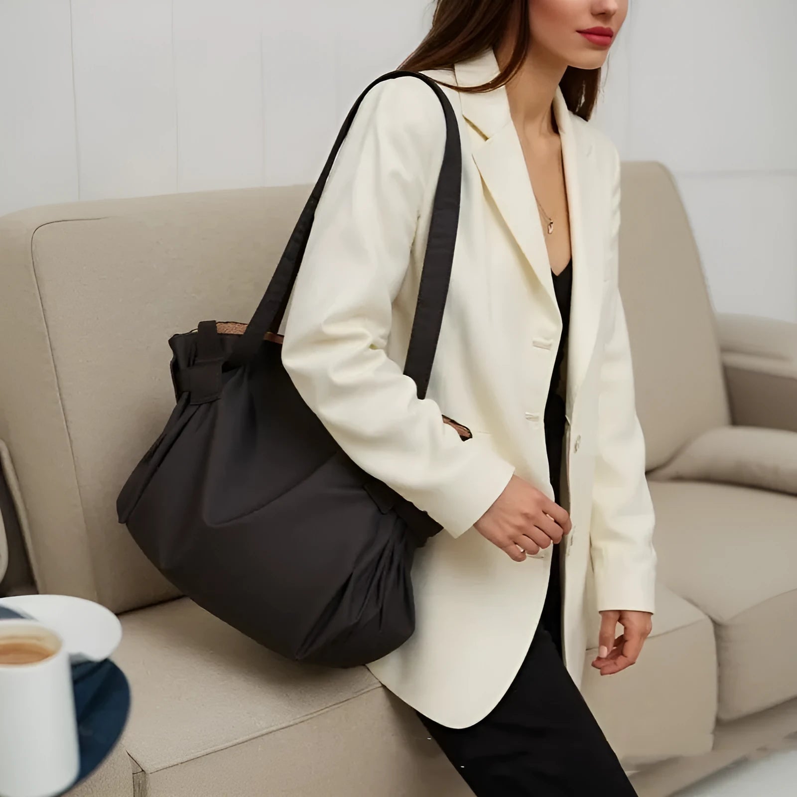Women's black expandable shoulder crossbody bag made from Oxford cloth for travel and daily use.