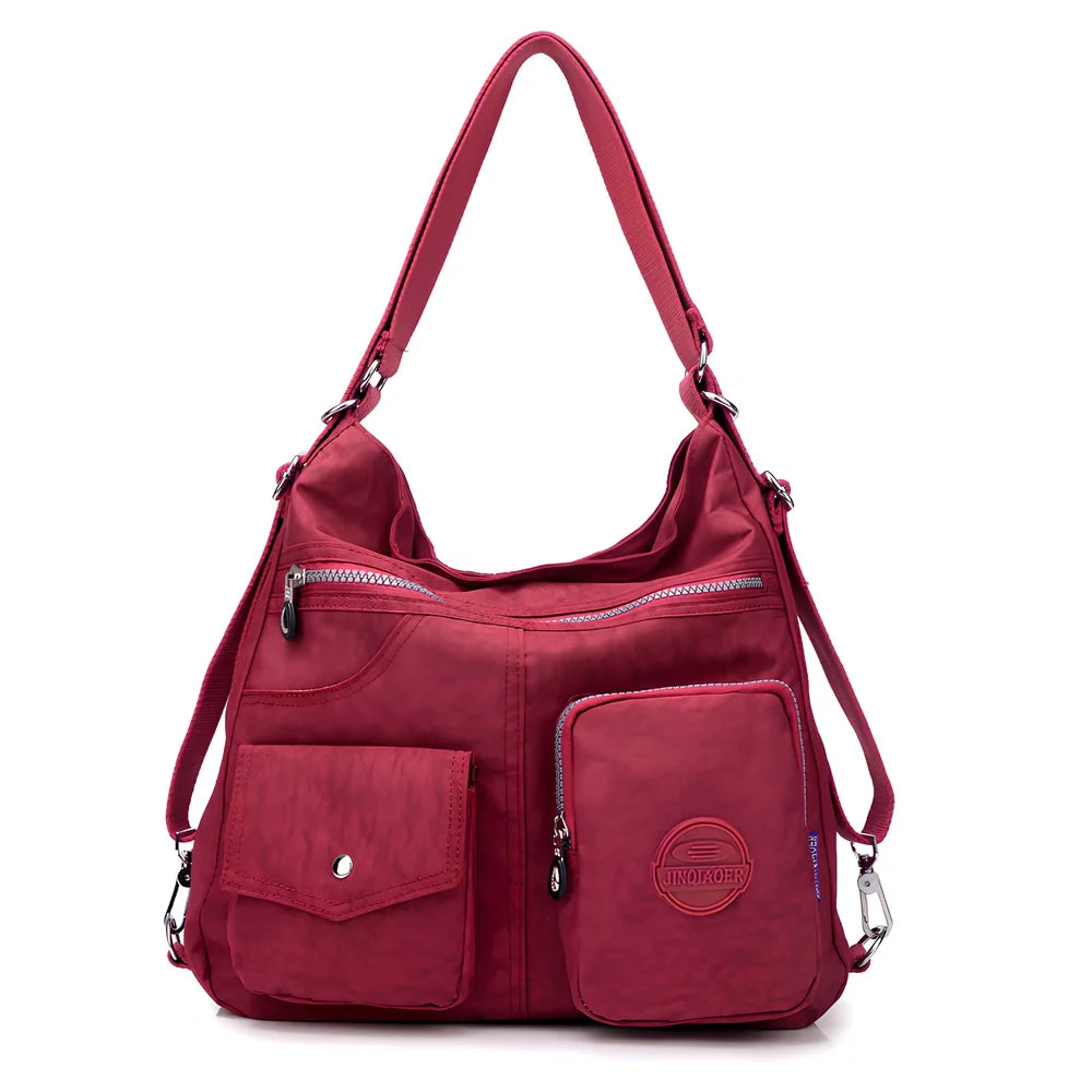 Women's waterproof nylon crossbody bag with organizational pockets and 34cm laptop capacity