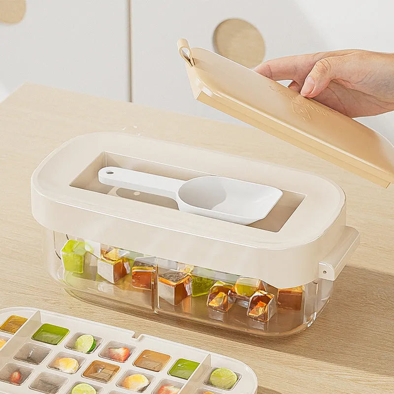 Colourful high-capacity ice cube tray with grid design and an ice shovel stored in its slot.