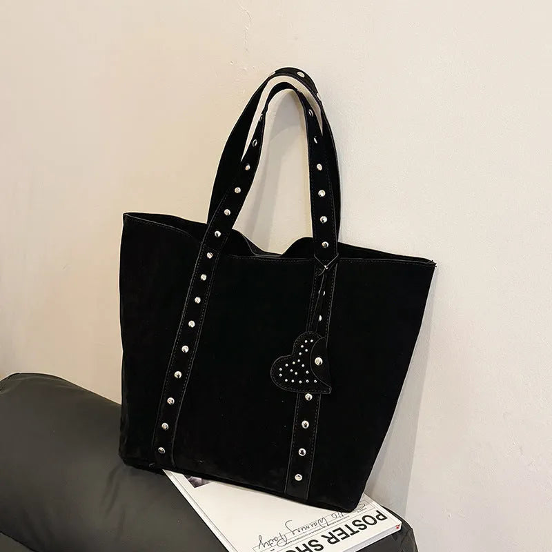 Black PU leather tote bag with double shoulder straps, showing interior sandwich pocket organiser.