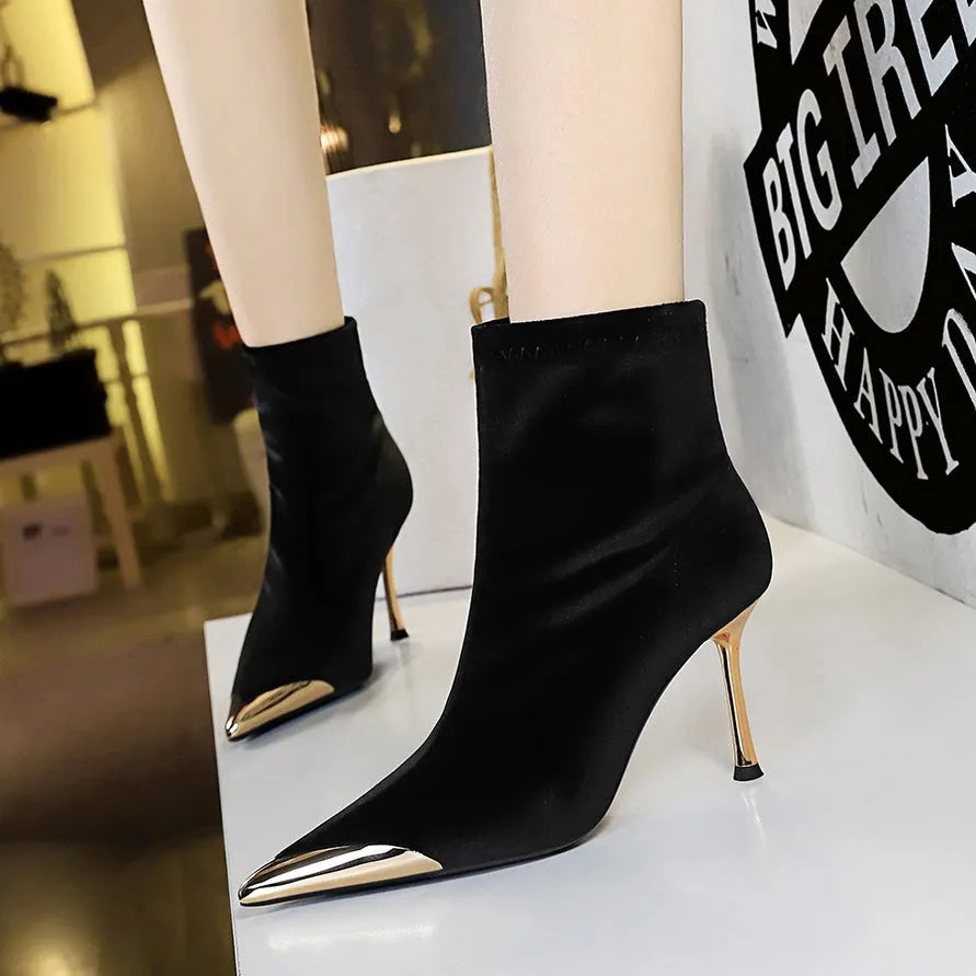 Women's suede stiletto heel ankle boots in black with pointed toe and metal detail