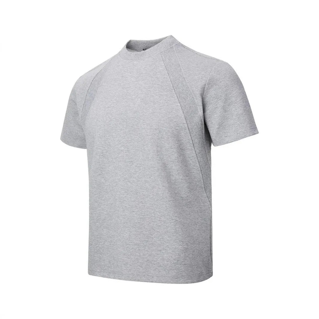 Man wearing a loose grey short sleeve top with visible air layer texture stitching on the front.