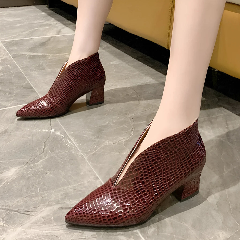 Women's black V-cut pointed toe ankle boots with embossed detail and a chunky block heel.