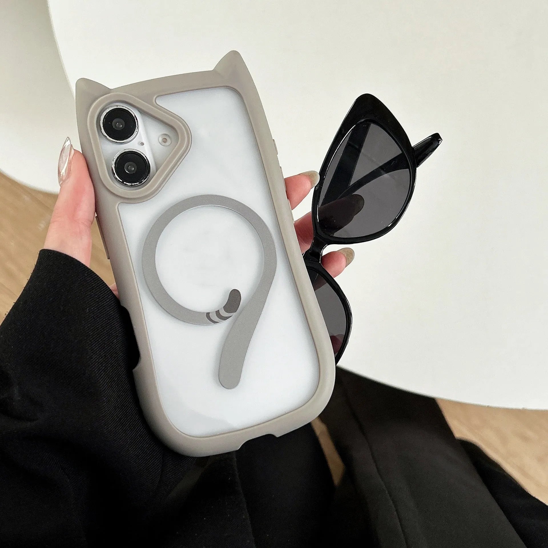 Transparent acrylic and black TPU phone case for iPhone 17 with a removable airbag component.
