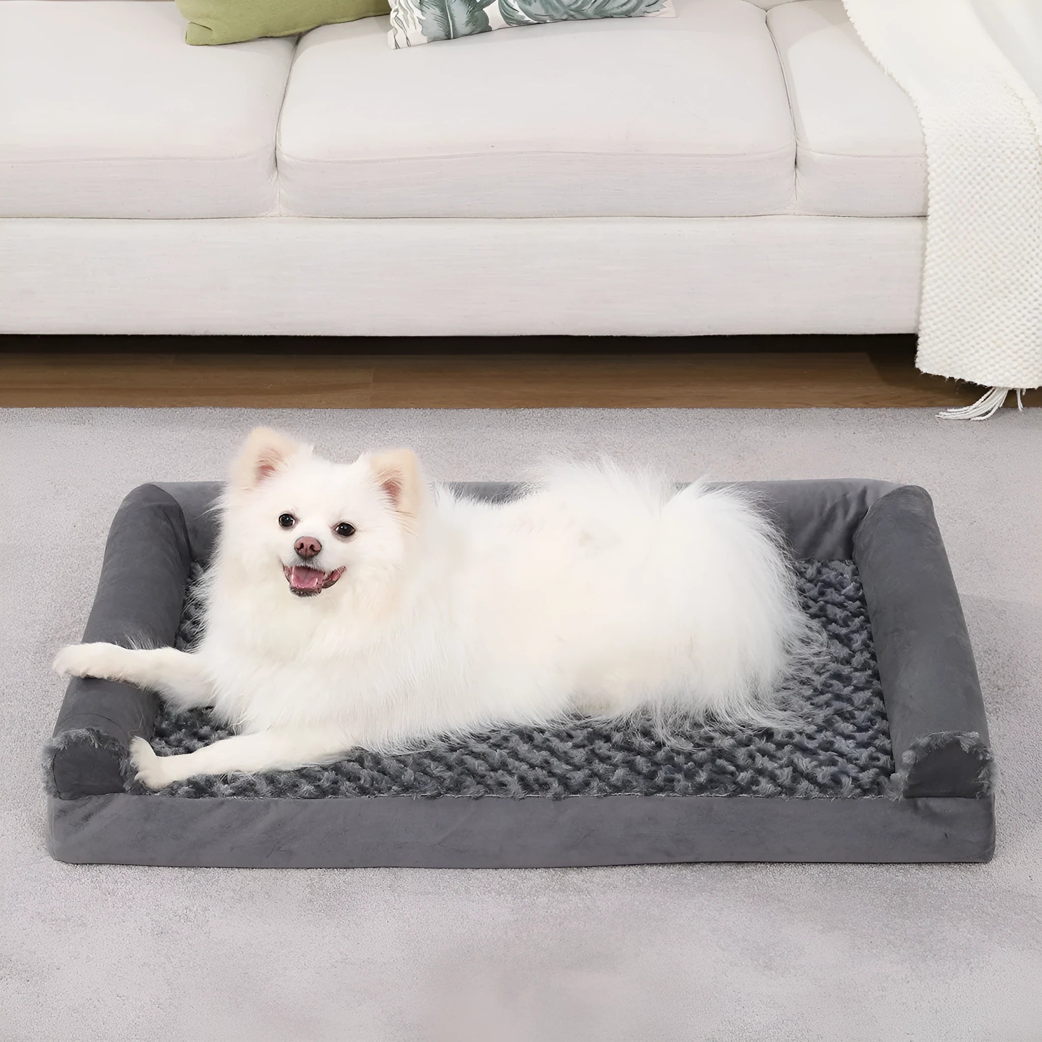 Grey U-shaped dog sofa bed with textured velvet cover and sponge padding.