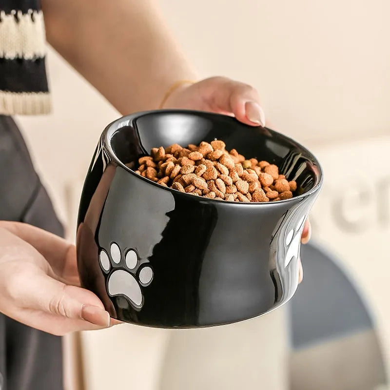 Ceramic cat bowl with slanted mouth design showing cat's paw pattern in yellow colour