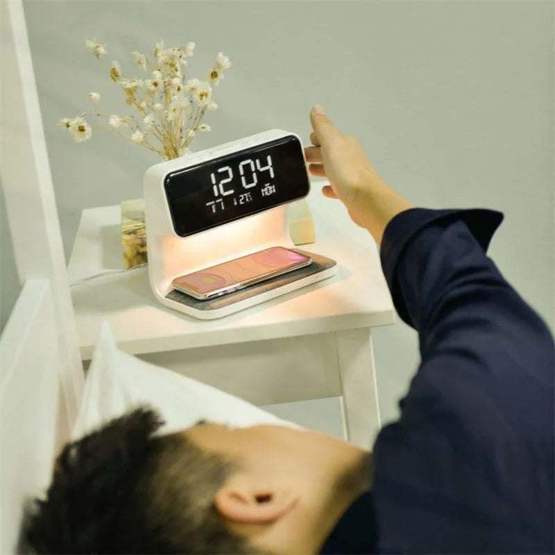 White 3-in-1 bedside lamp with wireless charging pad, LCD alarm clock screen, and touch-sensitive dimming control.
