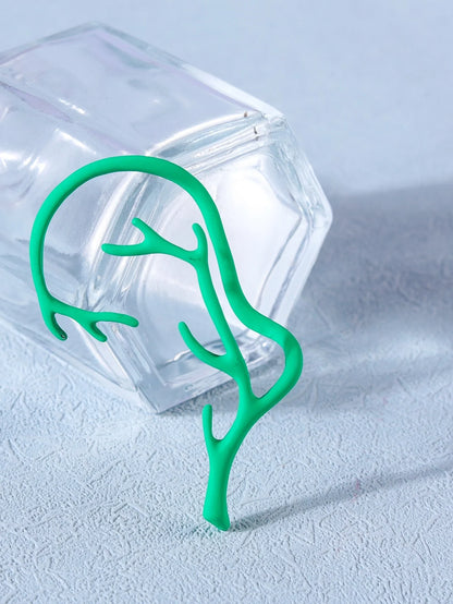 Vintage bone hypoallergenic elf earrings in gold, silver, black, and green with geometric design