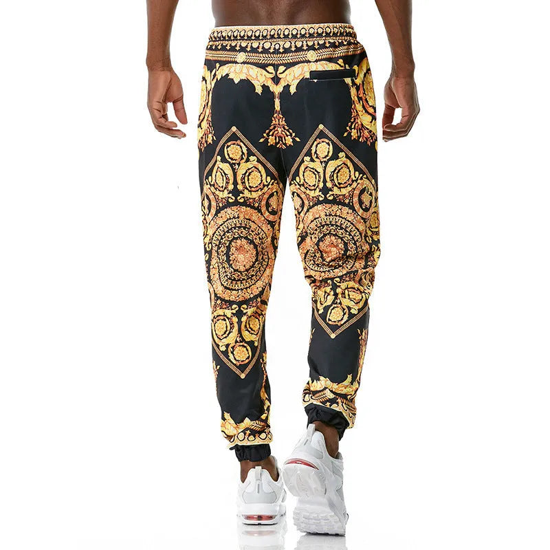 Printed jogging pants in loose fit with digital print pattern, mid waist, drawstring belt, and small-foot ribbed hem