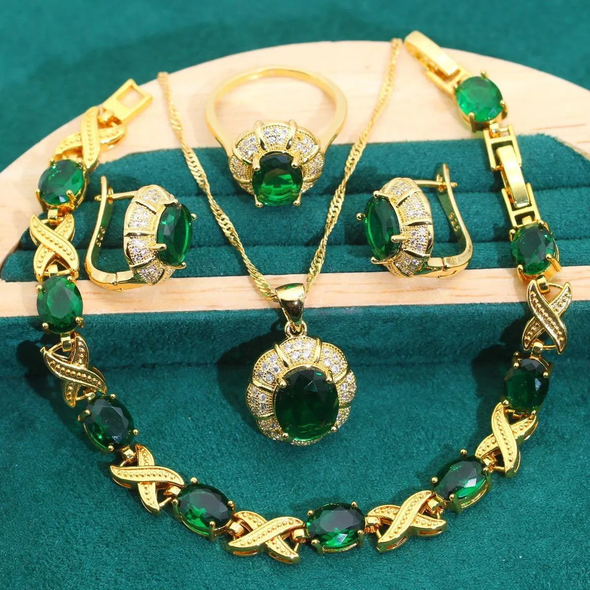 Gold plated jewellery set with coloured cubic zirconia stones showing necklace, earrings, ring, and bracelet.