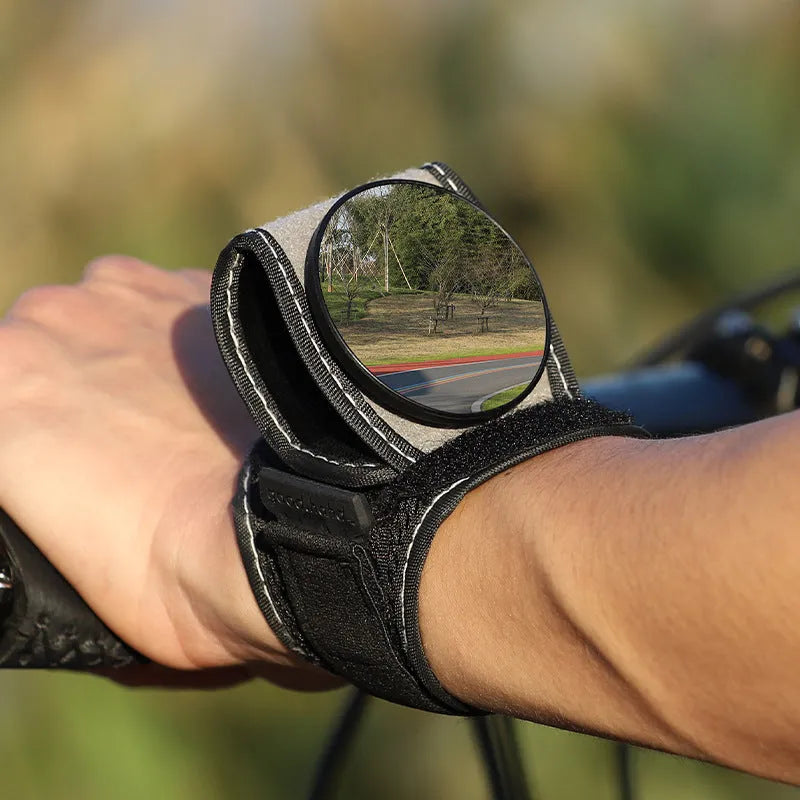 Black nylon bicycle rear-view mirror showing wrist mounting and adjustable viewing mechanism