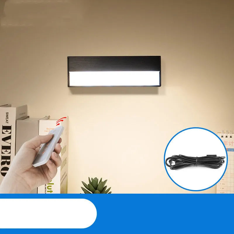 Small white magnetic LED desk lamp with adjustable brightness on a metallic surface