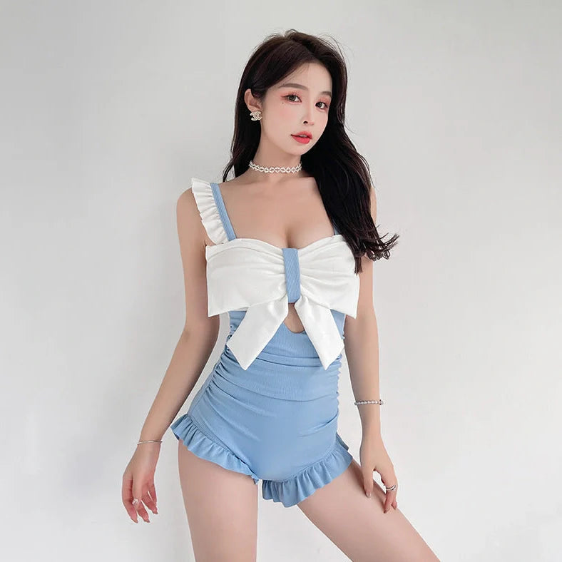 Women's one-piece swimsuit with adjustable bow detailing in solid colour