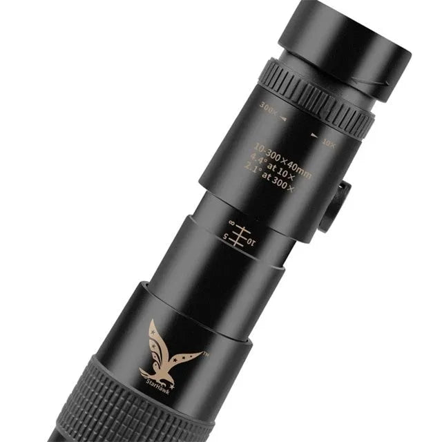 Black telescopic monocular 10-300x40mm with BAK4 prism and phone clip attached, on outdoor background