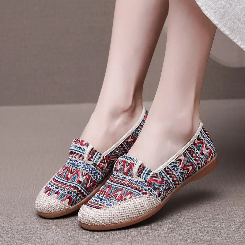 Women's flat heel ethnic cloth shoes in blue with colour stitching detail on a low-top, shallow mouth design.