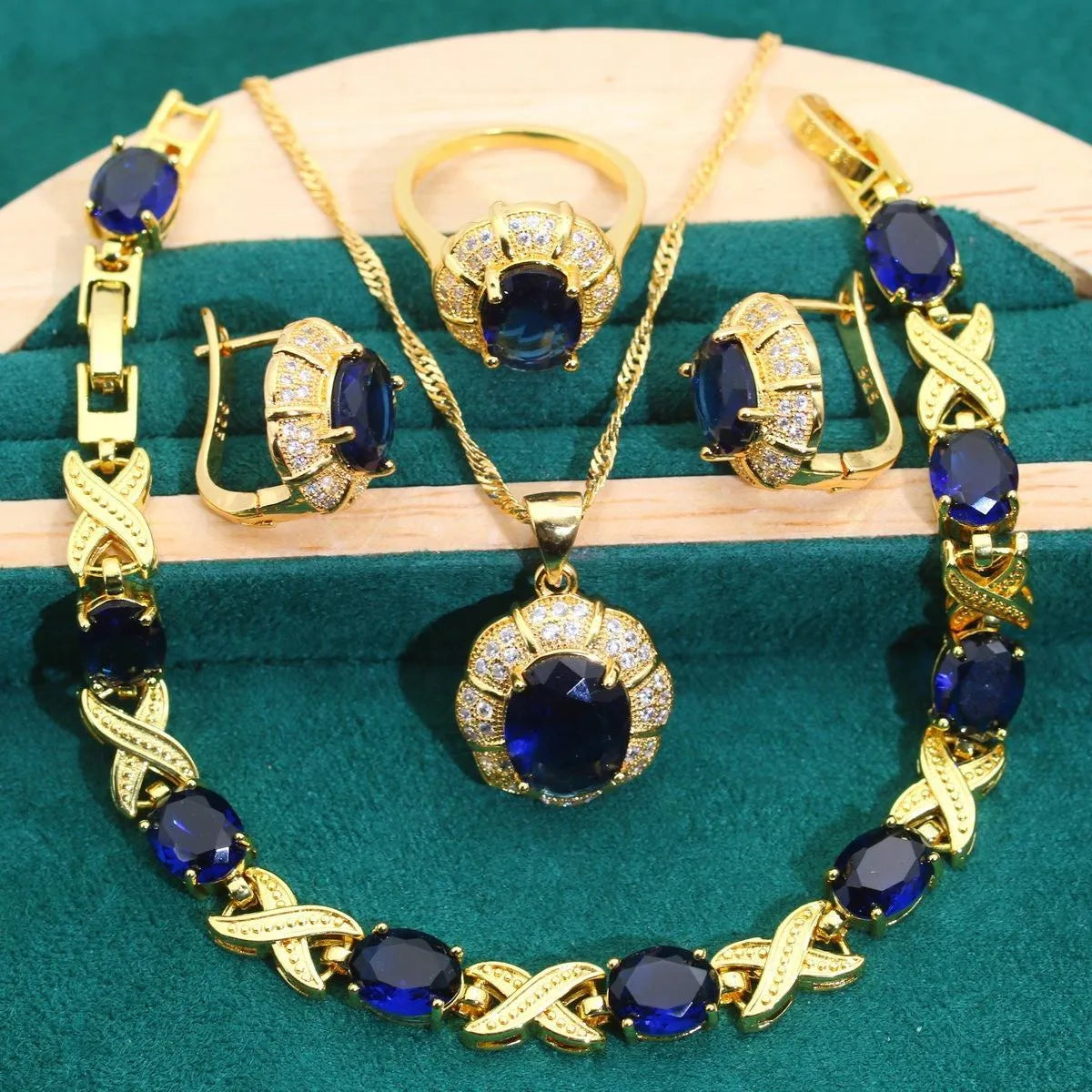Gold plated jewellery set with coloured cubic zirconia stones showing necklace, earrings, ring, and bracelet.