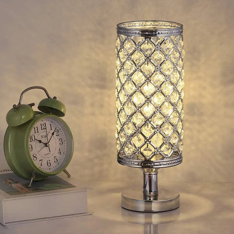 Modern crystal table lamp with metal base and hollow-carved shade in gold finish