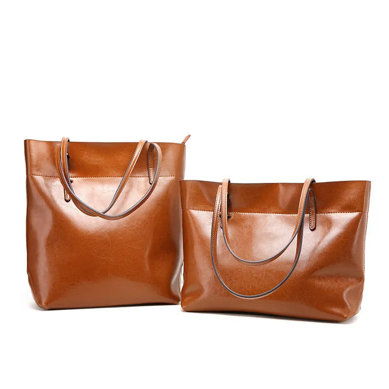 Brown cowhide leather cross body ladies handbag showing two main compartments and internal phone pouch.