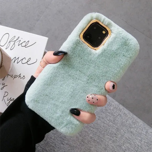 A soft apricot-coloured silicone rabbit plush phone case for an iPhone, showing the raised camera circle and side buttons.