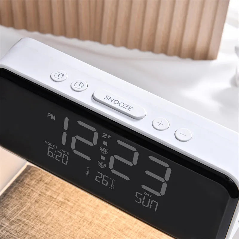 White 3-in-1 bedside lamp with wireless charging pad, LCD alarm clock screen, and touch-sensitive dimming control.