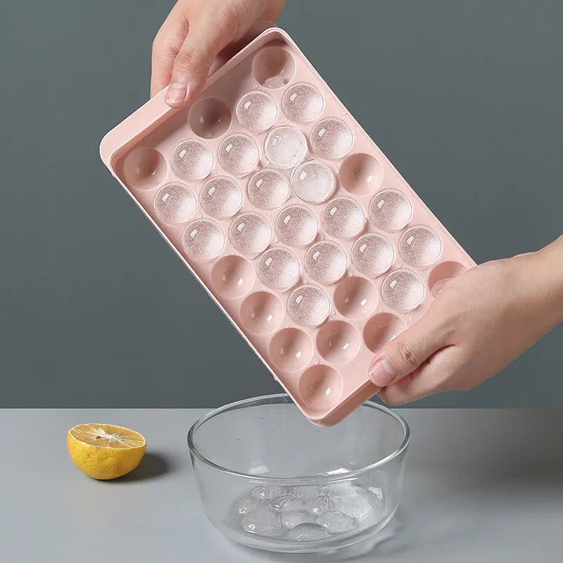 Sky blue and pink round ball ice cube trays showing 18 and 33 grid options