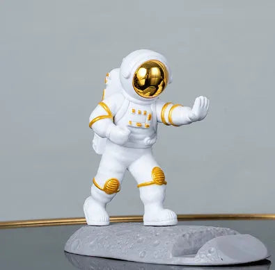 Plastic astronaut decoration mobile phone holder in blue colour on a desk
