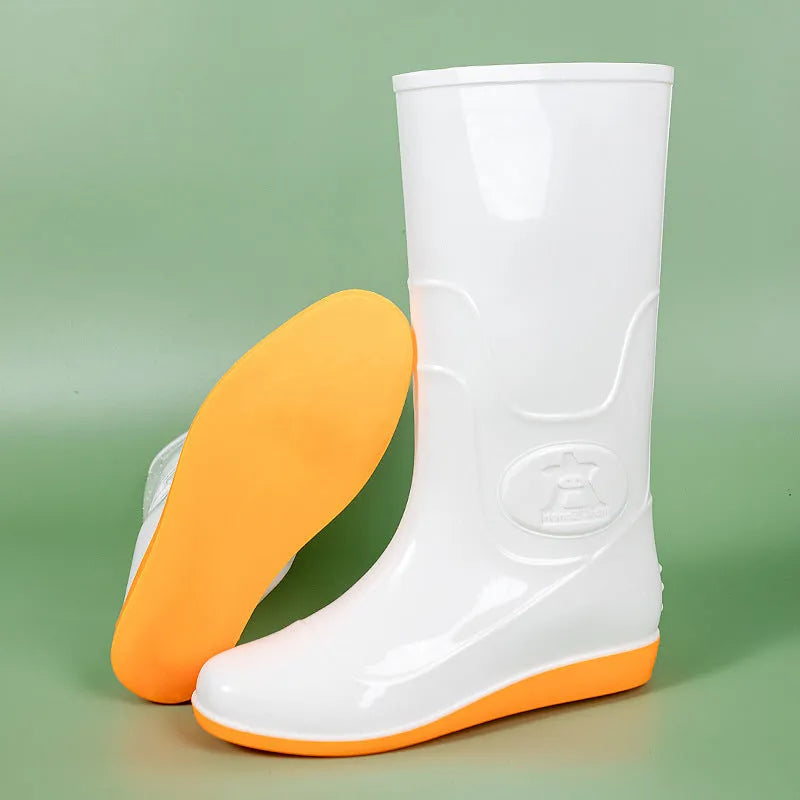 White and yellow high tube plastic rain boots with flat heel and round toe.