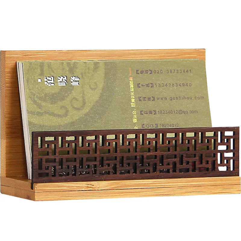 Geometric bamboo and black walnut business card holder on a desk