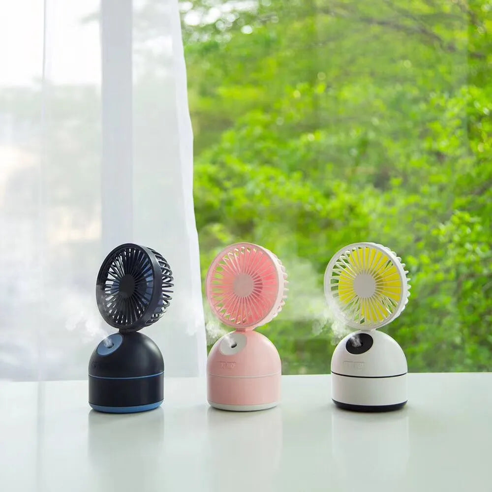 Portable USB fan humidifier in white with cool mist output and integrated fan, placed on a desk