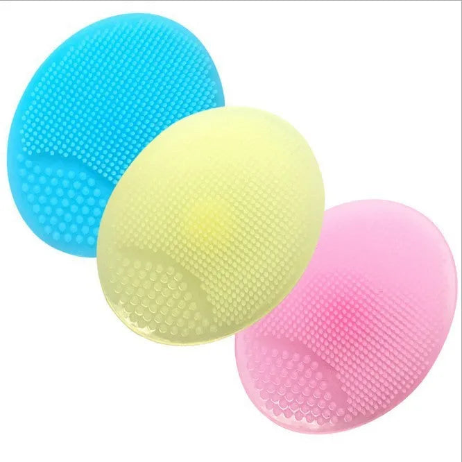 Silicone facial brush in three bristle zones with suction cup on blue background