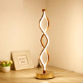 Gold LED desk lamp with acrylic shade and aluminium body on a desk
