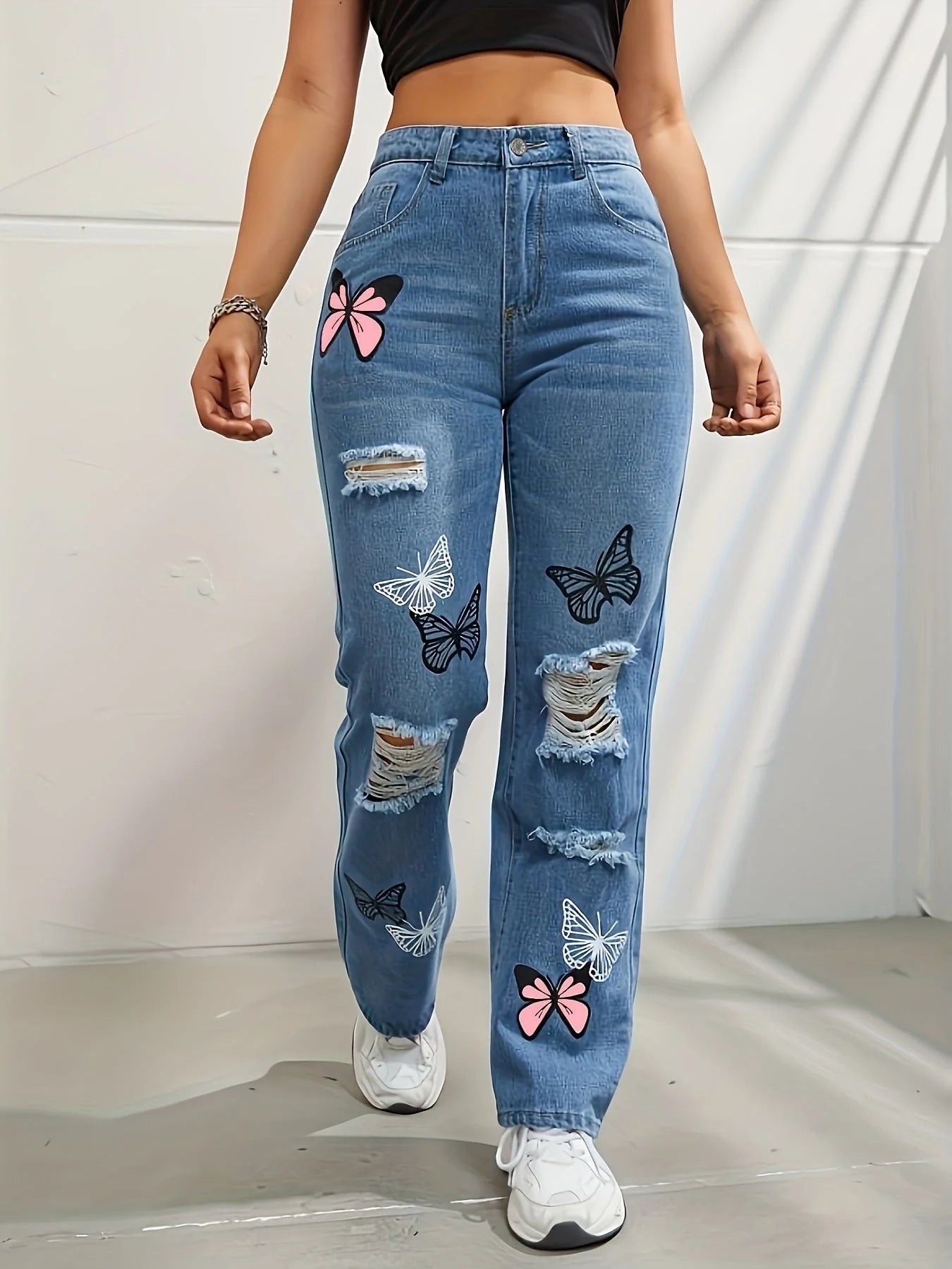 Women's high-waisted straight-leg jeans with butterfly print and distressed details