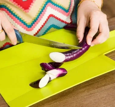 Green folding plastic cutting board 37.5cm x 21cm with non-slip texture and hanging hole on a kitchen counter