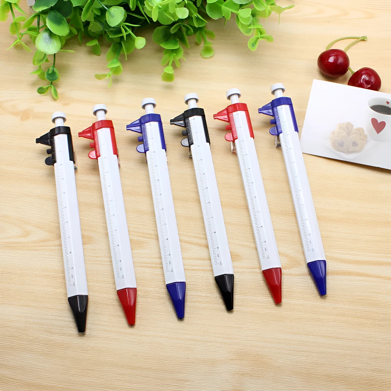 A multifunction orange ballpoint pen with a built-in silver slide vernier caliper, 15cm long.