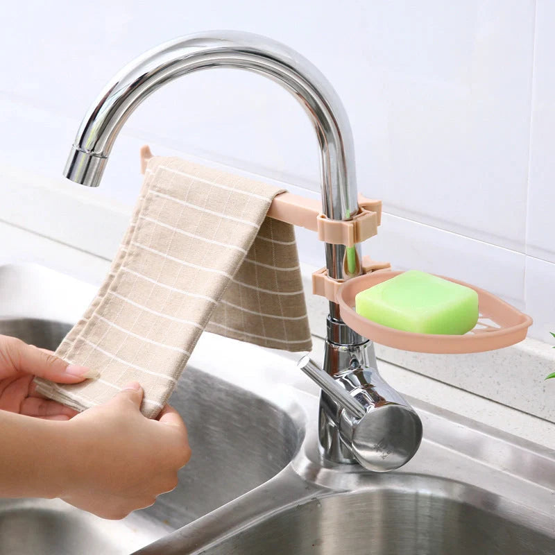 Clip-on adjustable sink drain basket in pink and light green, organising soap and towels