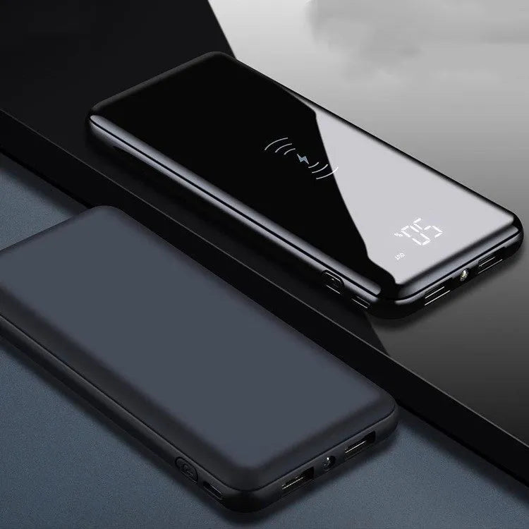 Multifunctional mirror wireless charger with silver mirror finish and built-in lithium battery on a wooden desk.