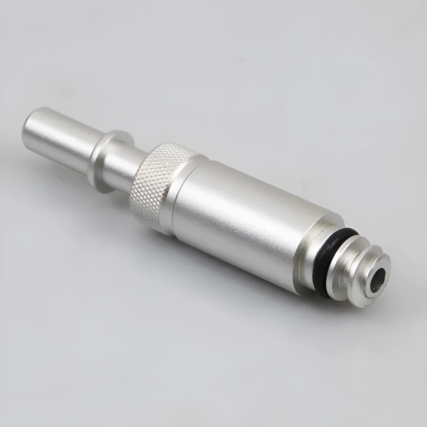 Silver metal VAS6262-9 transmission oil refueling adapter tool on a workshop bench.