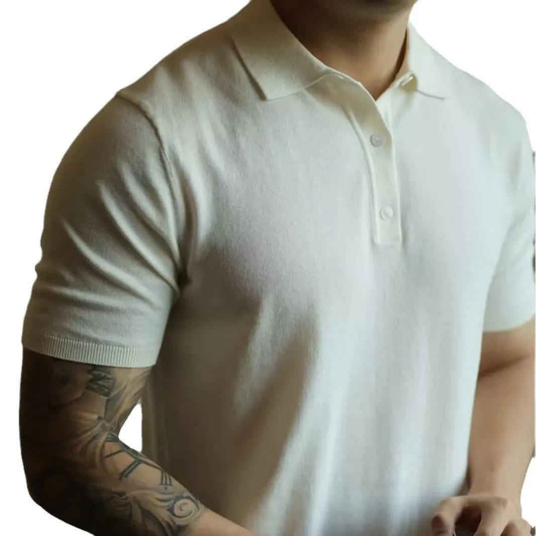 Men's black polo shirt with knitted collar and short sleeves laid flat.