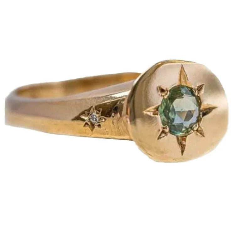Gold-colour adjustable star ring with a central asterism zircon on a zinc alloy band.