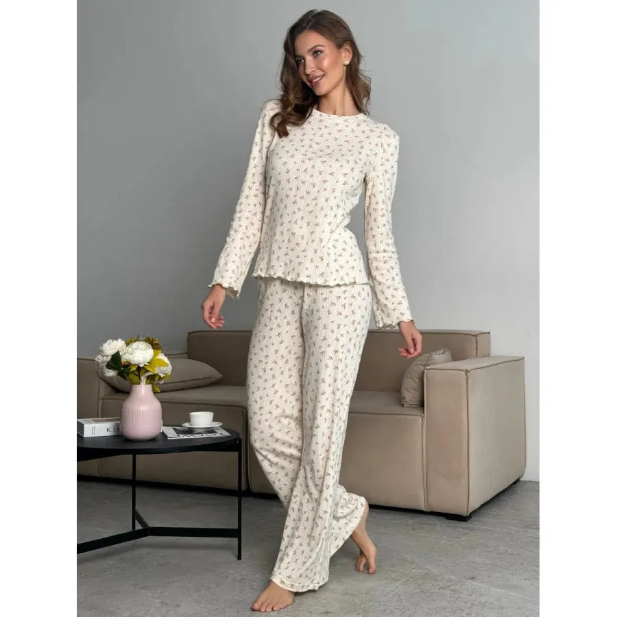 White women's floral print lounge suit with long bell sleeve top and wide leg trousers.