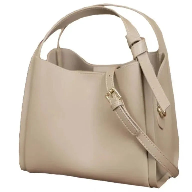 Women's soft cowhide crossbody bucket bag showing interior zipper compartments and sewing thread detailing