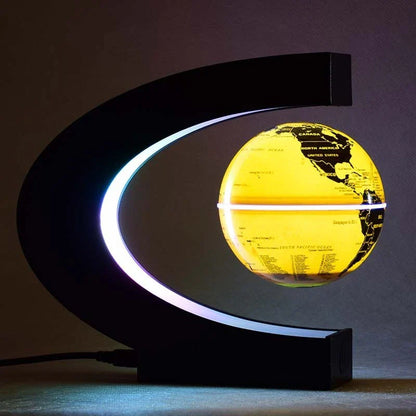 Magnetic levitation globe floating above base with LED light on