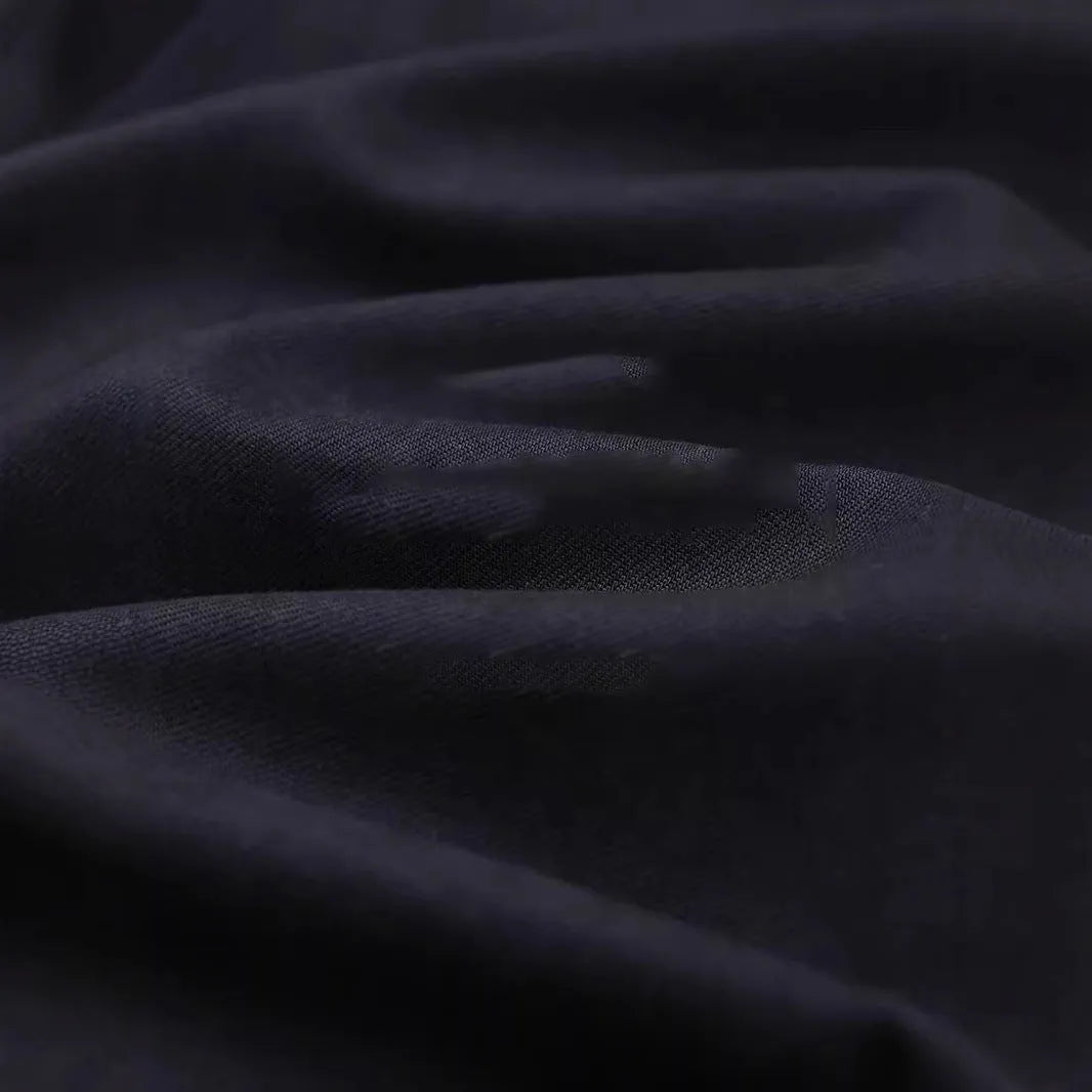 Men's light sand rice coloured casual shirt with simple lapel and long sleeves on a hanger.