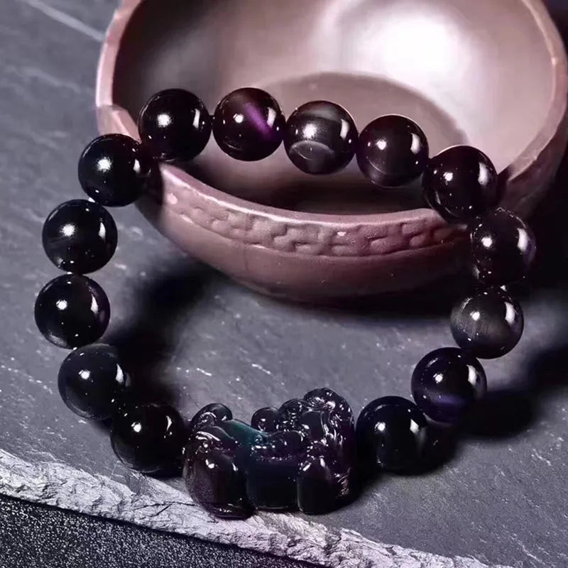 Natural Ice Obsidian beaded bracelet on wrist showing pale crystal beads.