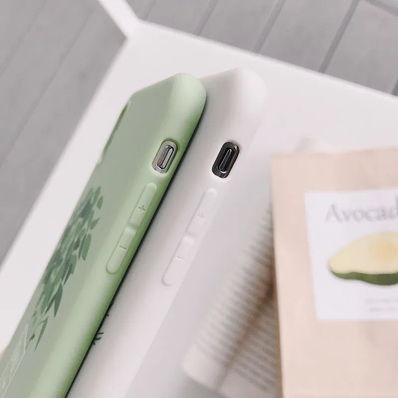 White silicone iPhone case with painted plant pattern design showing 360-degree edge protection