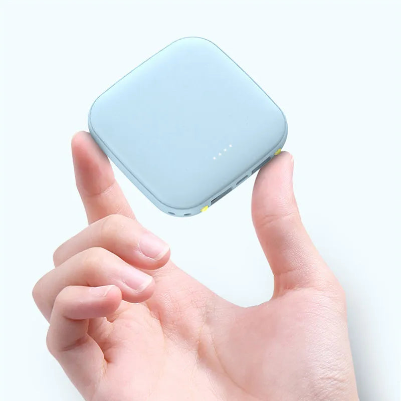 Portable 10000mAh power bank with multi-USB ports in black, white, blue, and pink colours