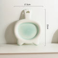 Blue ceramic cat bowl with shallow mouth and non-slip rubber base on a kitchen counter.