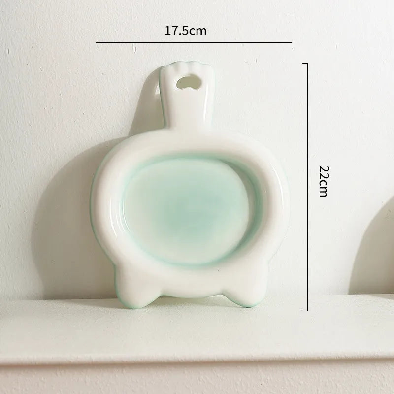 Blue ceramic cat bowl with shallow mouth and non-slip rubber base on a kitchen counter.