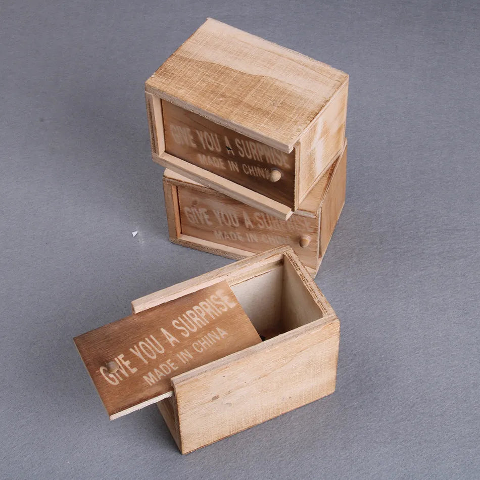 Wooden prank scare box closed on table, with random jumping animal surprise inside for April Fools' tricks.