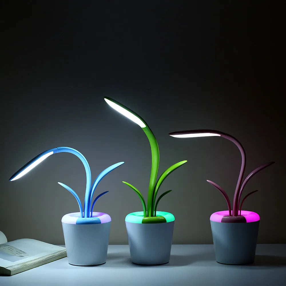 Modern rechargeable LED table lamp in pink with touch control and plant-shaped design on a wooden desk